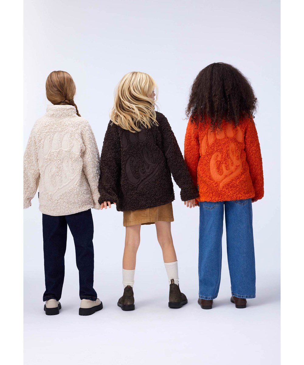 Ulan - Rising Sun - Orange fleece jacket for children made of recycled polyester with a nice back patch in durable nylon.