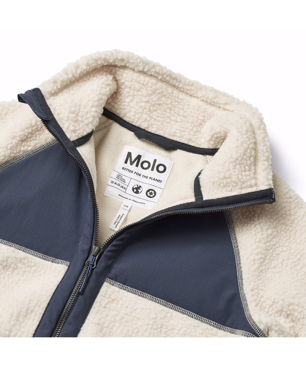 Usher - Summer Sand - Off-white fleece jacket for children in recycled polyester with front pockets and blue durable details.