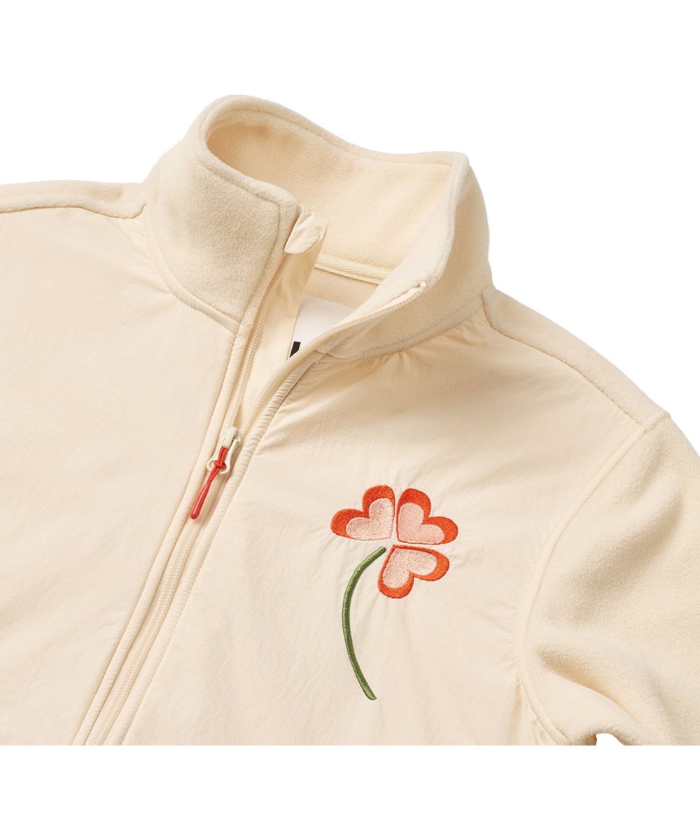 Utta - Pearled Ivory - Off-white fleece jacket for children made from recycled polyester with floral embroidery.