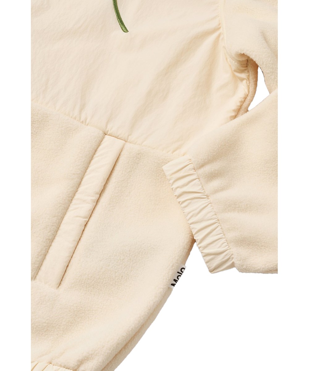 Utta - Pearled Ivory - Off-white fleece jacket for children made from recycled polyester with floral embroidery.