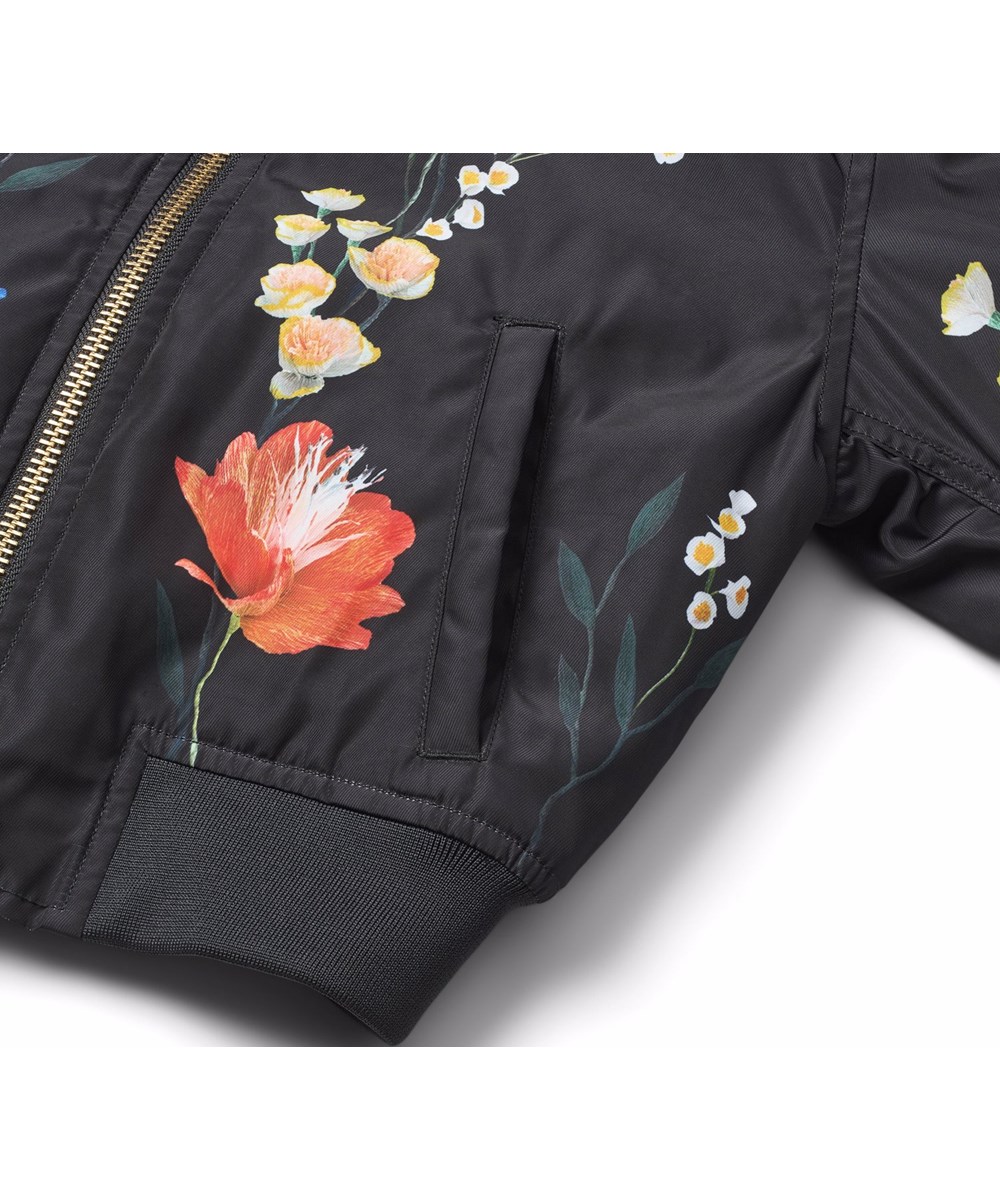 Hedia - Paper Flora - Black bomber jacket for children with a colourful floral print made from recycled polyester.