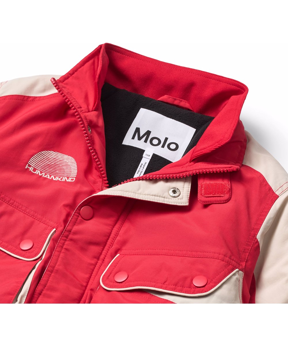 Herold - Vivid - Red and white jacket for children with an embroidered text on the back and sleeve, "Ingenuity humankind freedom".
