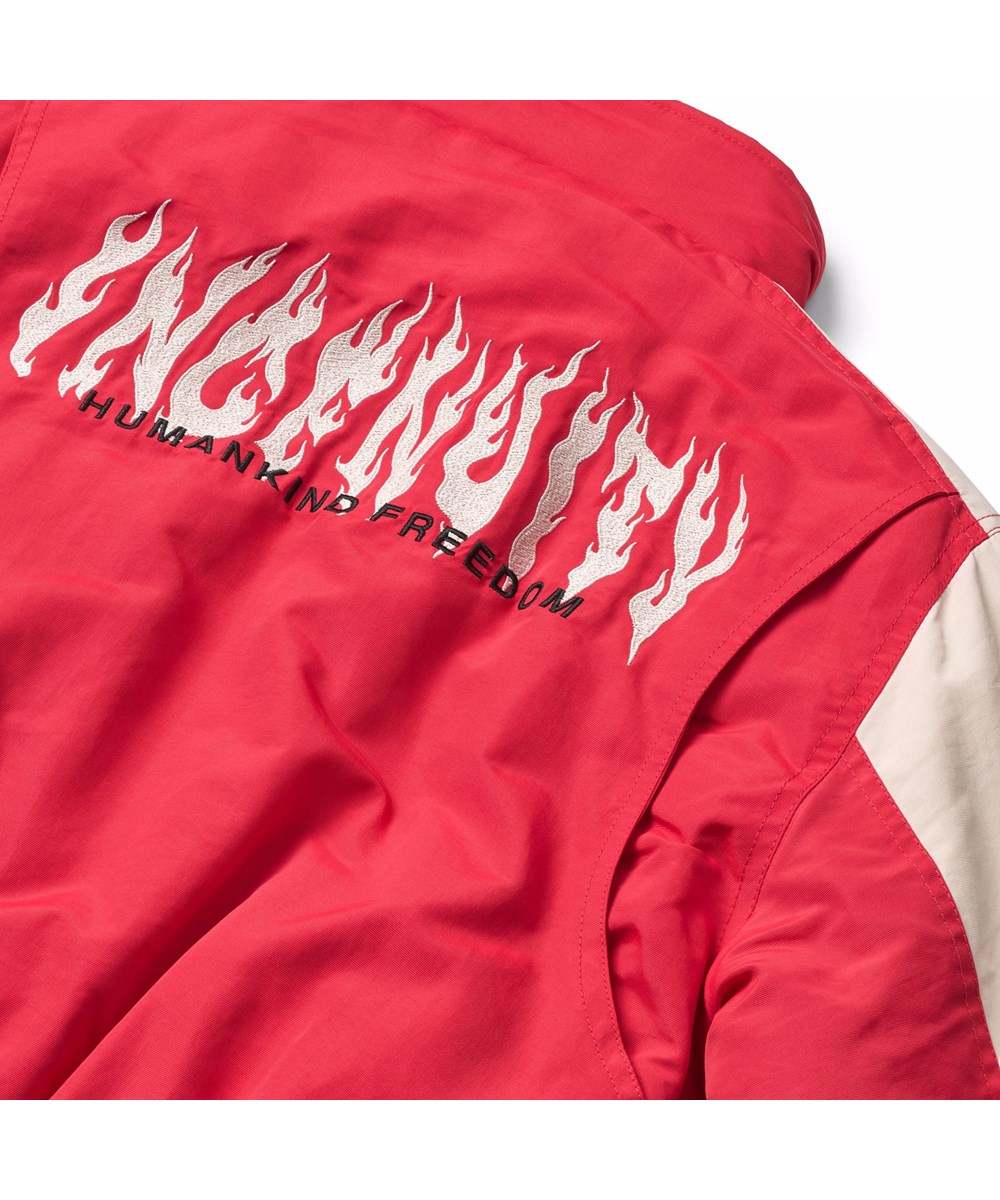 Herold - Vivid - Red and white jacket for children with an embroidered text on the back and sleeve, "Ingenuity humankind freedom".