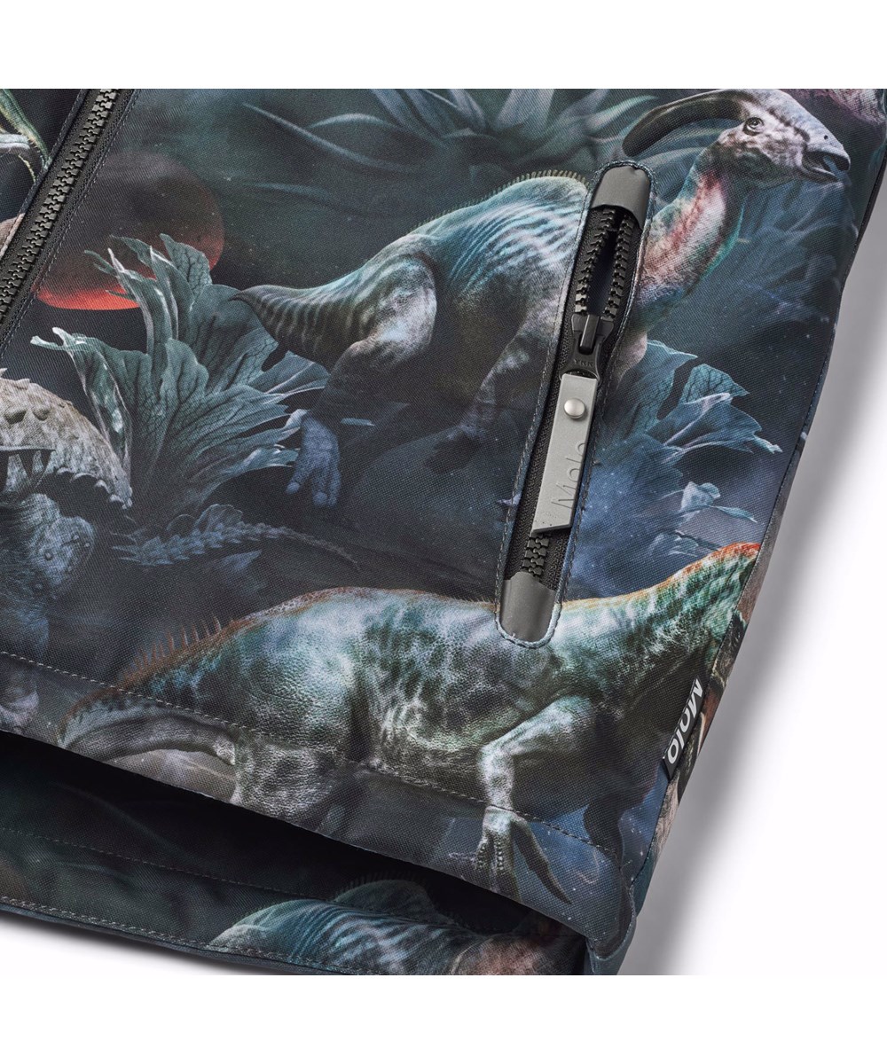 Castor - Dino In Space - Wind- and waterproof winter jacket for children in recycled polyester with a print of dinosaurs in space in shades of blue, green, and brown.