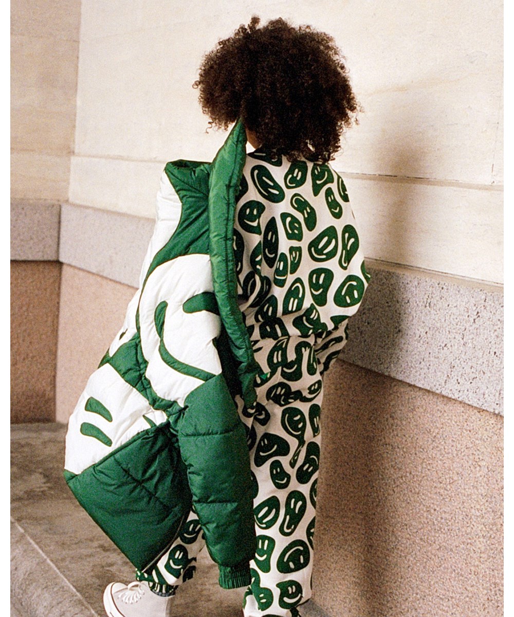 Hally - Woodland Smiles - Green puffer jacket with white smiley print on the back