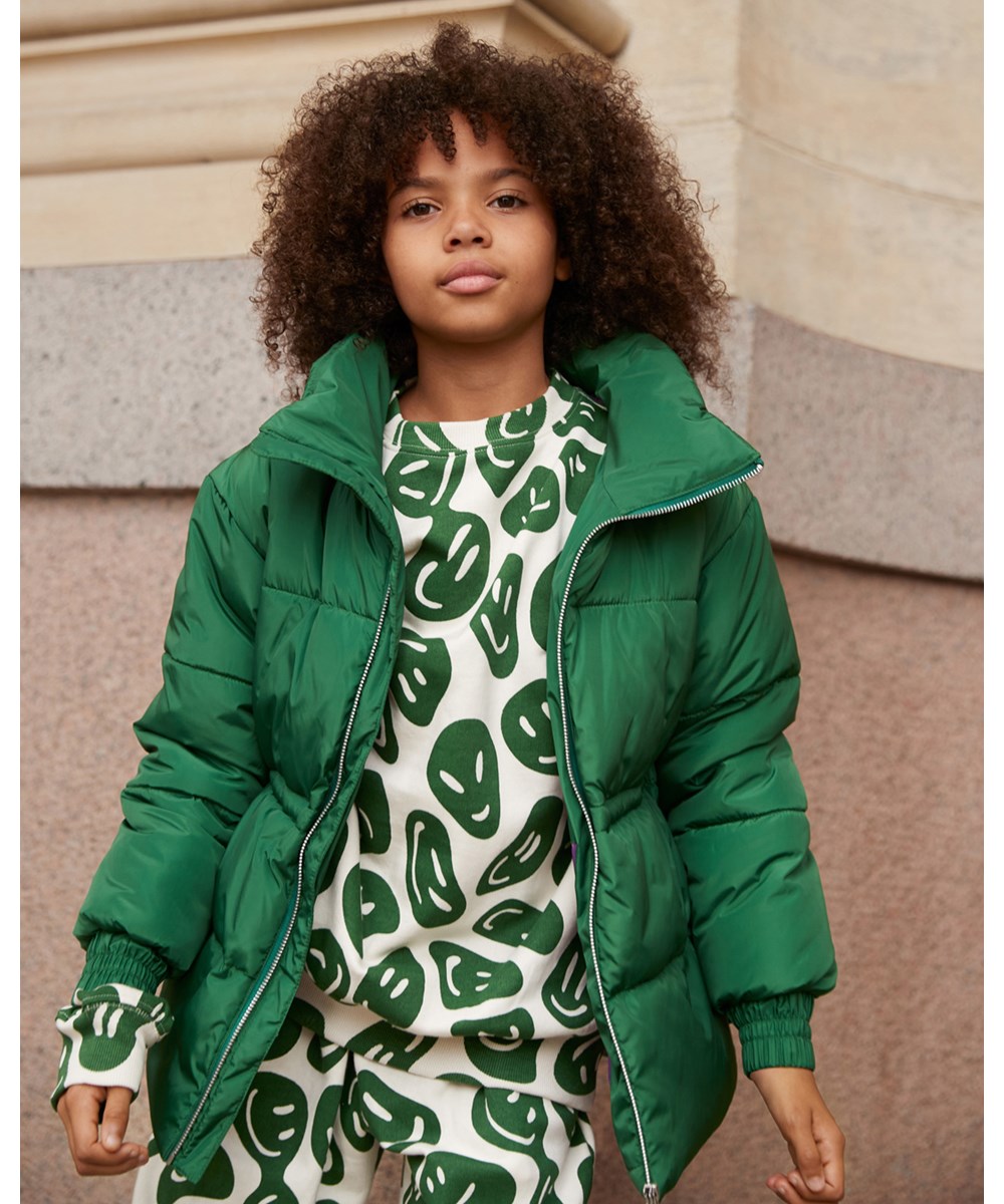 Hally - Woodland Smiles - Green puffer jacket with white smiley print on the back
