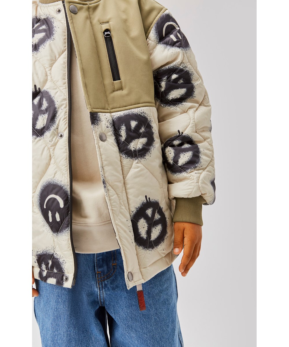 Harold - Happy Rock - Beige quilted jacket with a peace sign print 