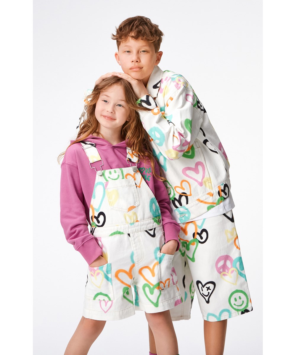 Hedly - Heart Colours - White denim, children's jacket with a print of graffiti spray painted smiling faces, hearts and peace signs.