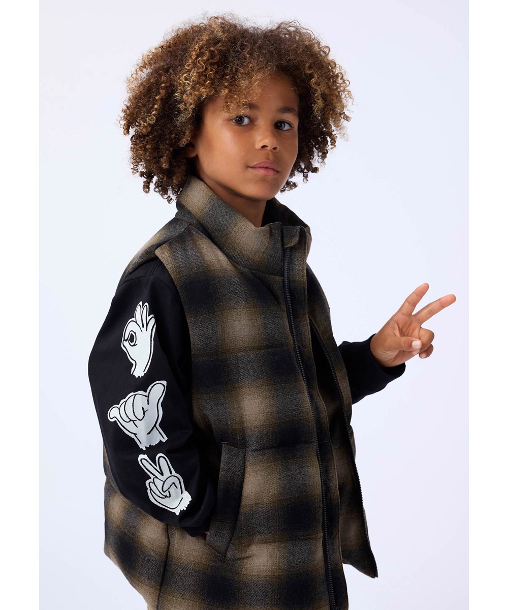 Heike - Bark Check - Checkered brown puffer vest for children made of recycled polyester and wool blend with internal adjustable elastic bands that keep the wind out.