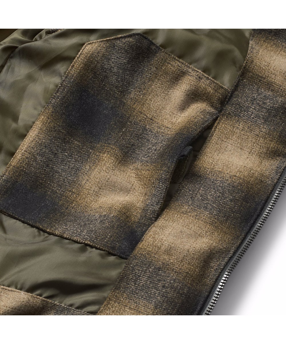 Heike - Bark Check - Checkered brown puffer vest for children made of recycled polyester and wool blend with internal adjustable elastic bands that keep the wind out.