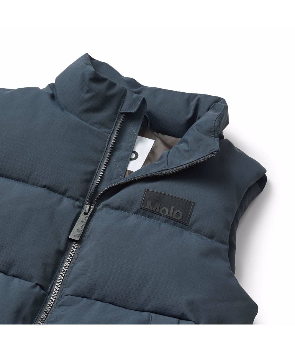 Heike - Night Navy - Dark blue puffer vest for children made of recycled nylon with a front zip, high collar and large armholes, allowing for a jacket or thick sweater to be worn underneath.