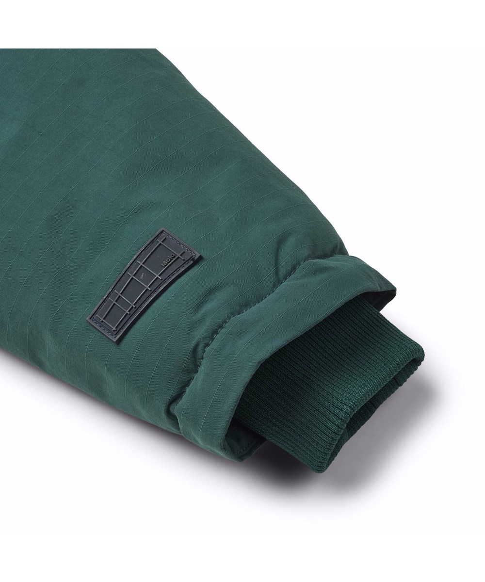 Heiko - Ponderosa Pine - Dark green wind- and waterproof winter jacket for children in recycled nylon.