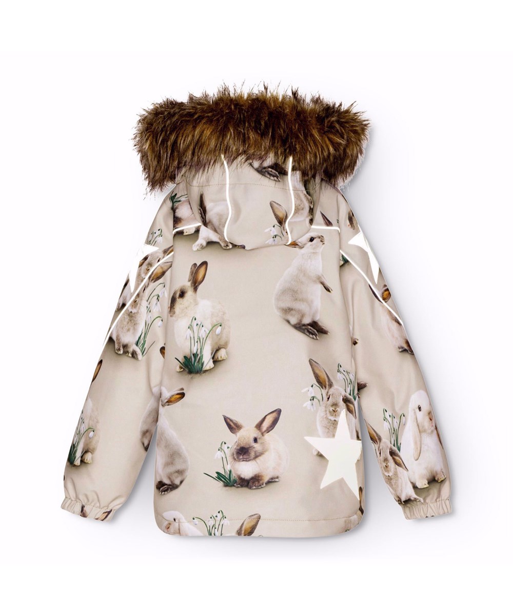Hopla Fur - Winter Rabbits - Wind- and waterproof winter jacket for children in recycled polyester with a print of cute rabbits among snowdrops on a grey background.