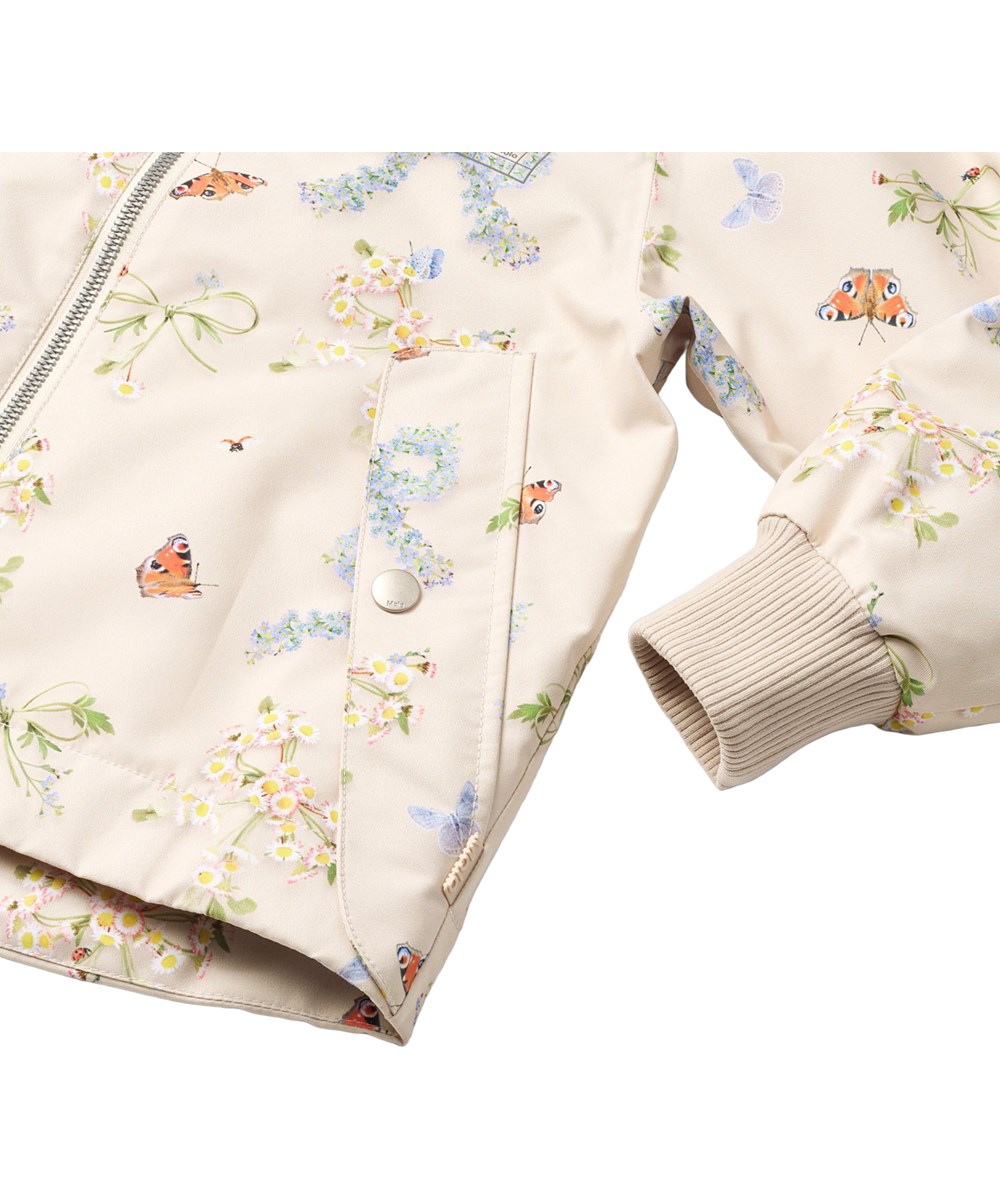 Hoplas - Floral Bows - Wind- and waterproof beige jacket for children made from recycled polyester.