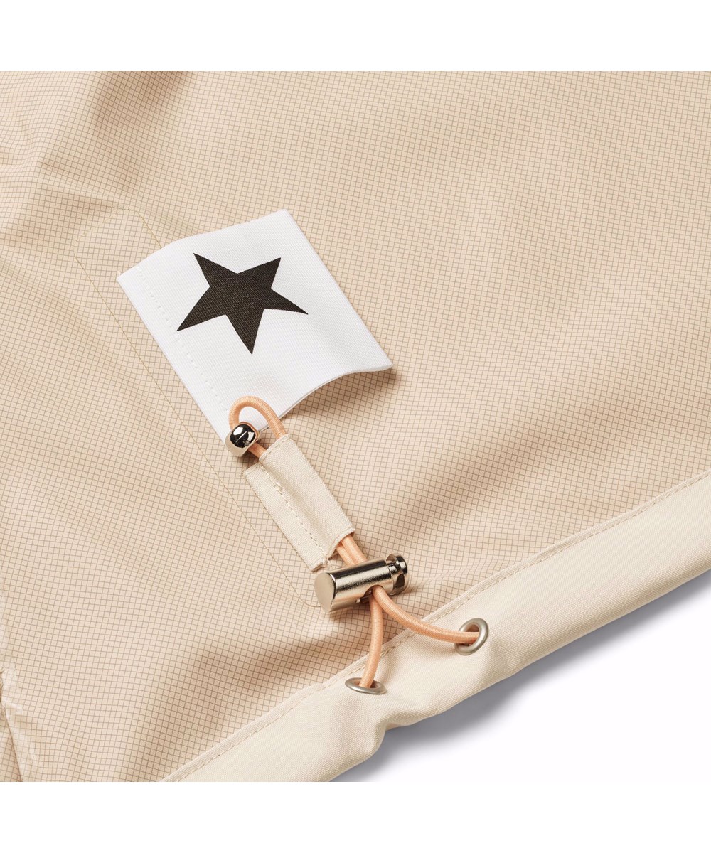 Horizon - Brazilian Sand - Beige wind- and waterproof jacket for children in recycled polyester with a hood.