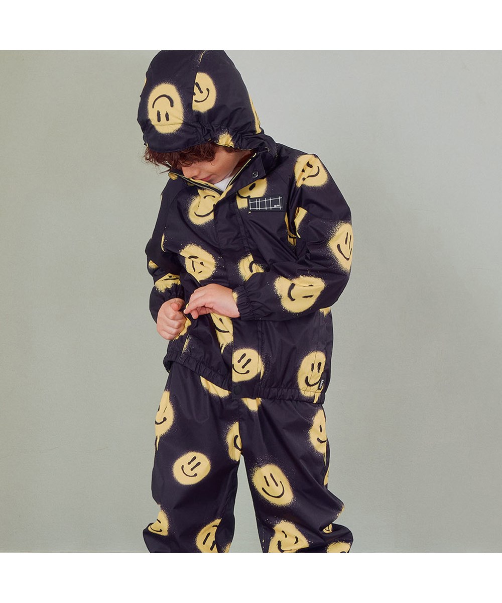 Waiton - Happy! - Lightweight and breathable rain jacket in black with smiley face print