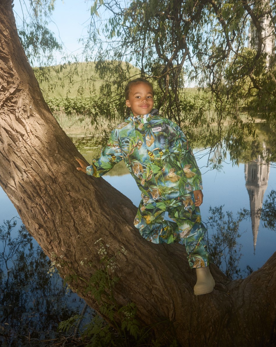 Waits - Jungle Life - Green wind and waterproof rain trousers for children in durable and recycled polyester.
