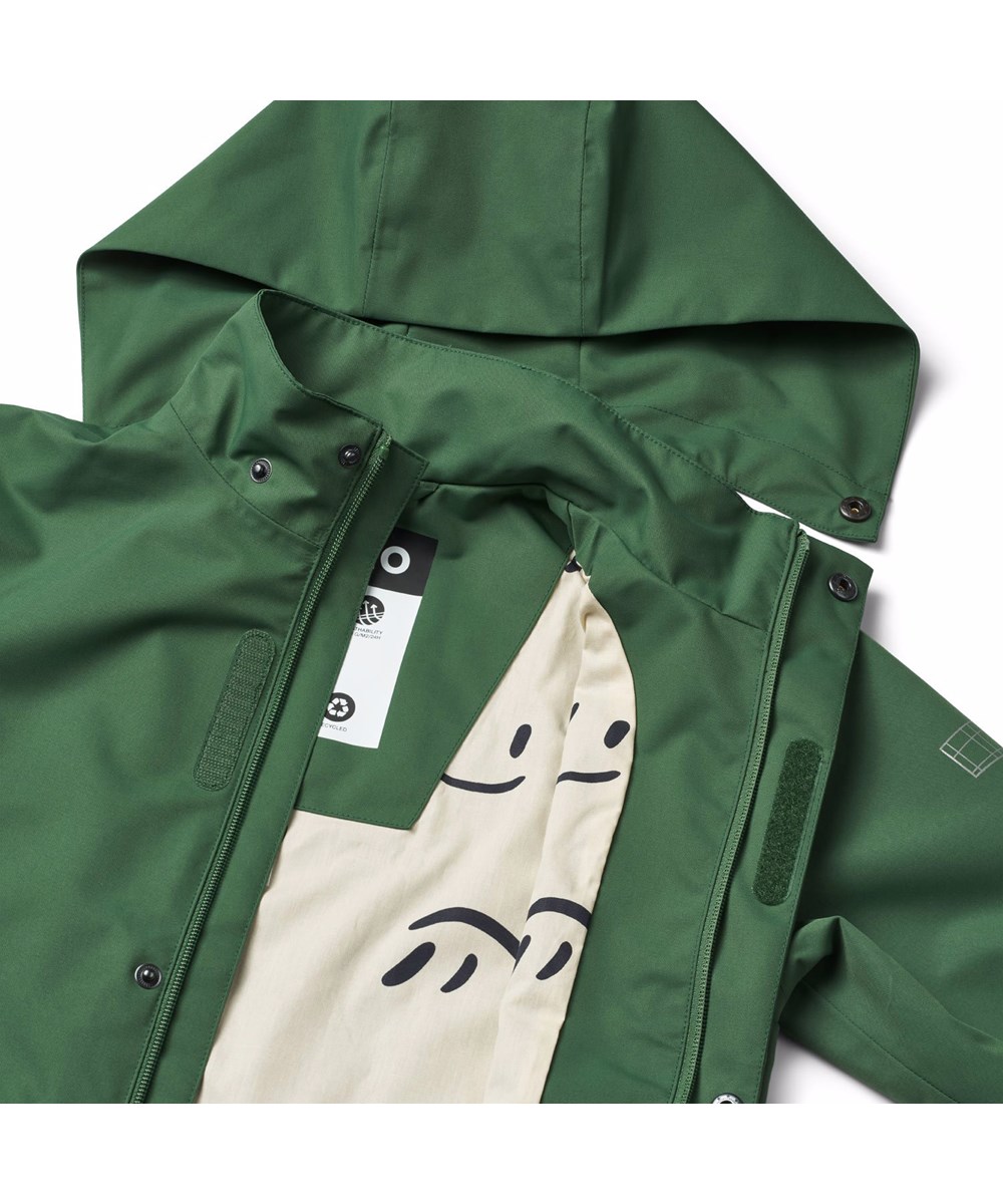 Windy - Rubber Tree - Green winde and waterproof raincoat for children in recycled polyester with detachable hood.