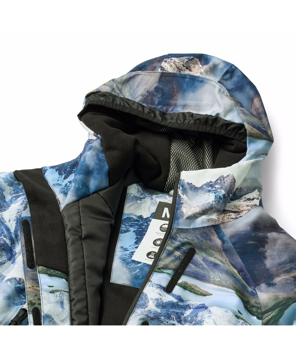 Hux - Snowy Mountains - Wind and waterproof jumpsuit with a beautiful landscape print, showing snow-covered mountain tops in vivid colors made from recycled polyester and padded with 3M™ Thinsulate™.