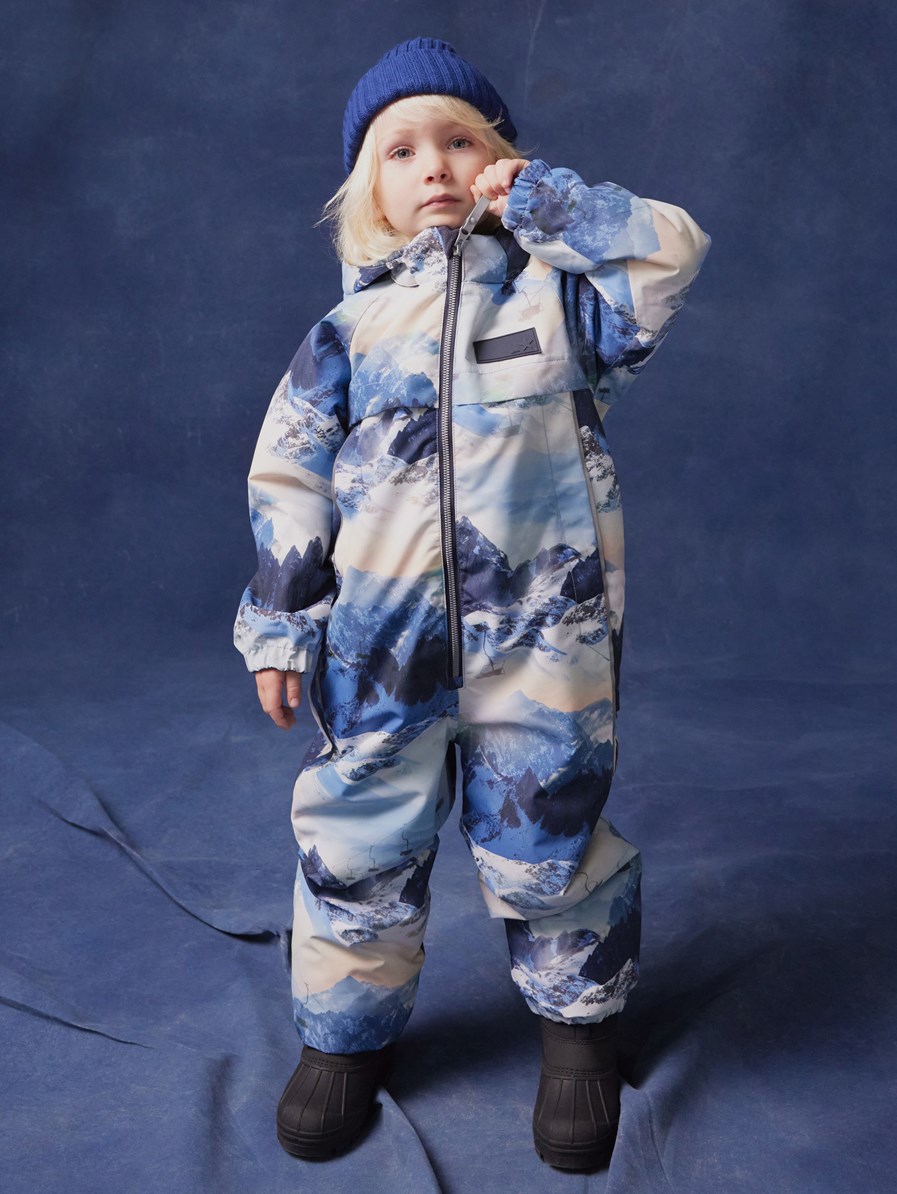 Pingo - Mountain High - Children's snowsuit in recycled polyester with a winter landscape print in shades of blue.