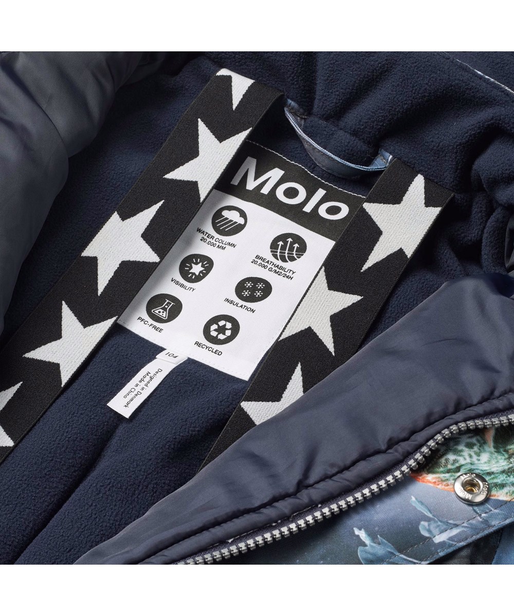 Polaris - Dino In Space - Children's snowsuit in recycled polyester with a cool print of wild dinosaurs in dark blue and brown shades.