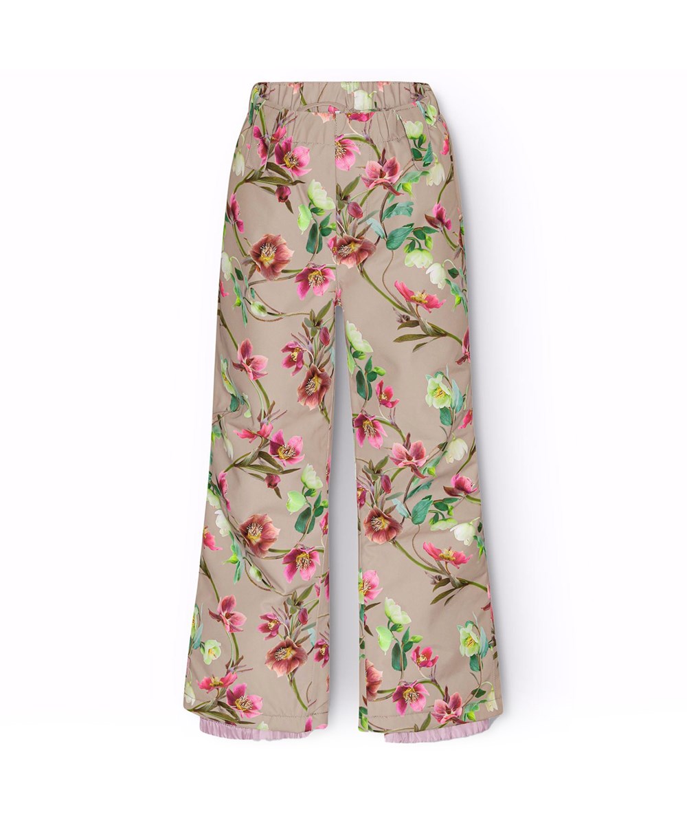 Paxton - Winter Roses - Overtræksbukser i genanvendt polyester, med et print af juleroser i hvide og lyserøde nuancer, som grener sig flot sammen i deres grønne blade på en mokkafarvet baggrund. 