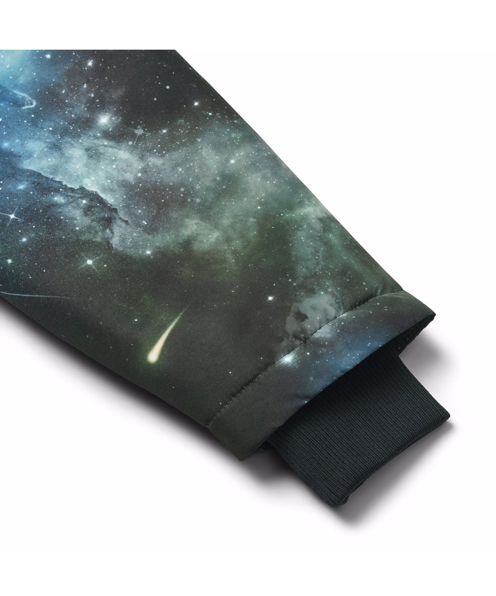 Heiko - Far Out - Vind- og vandafvisende jakke til børn med spaceprint i genanvendt nylon. Jakken har praktisk lynlåslukning, høj krave og aftagelig foret hætte.