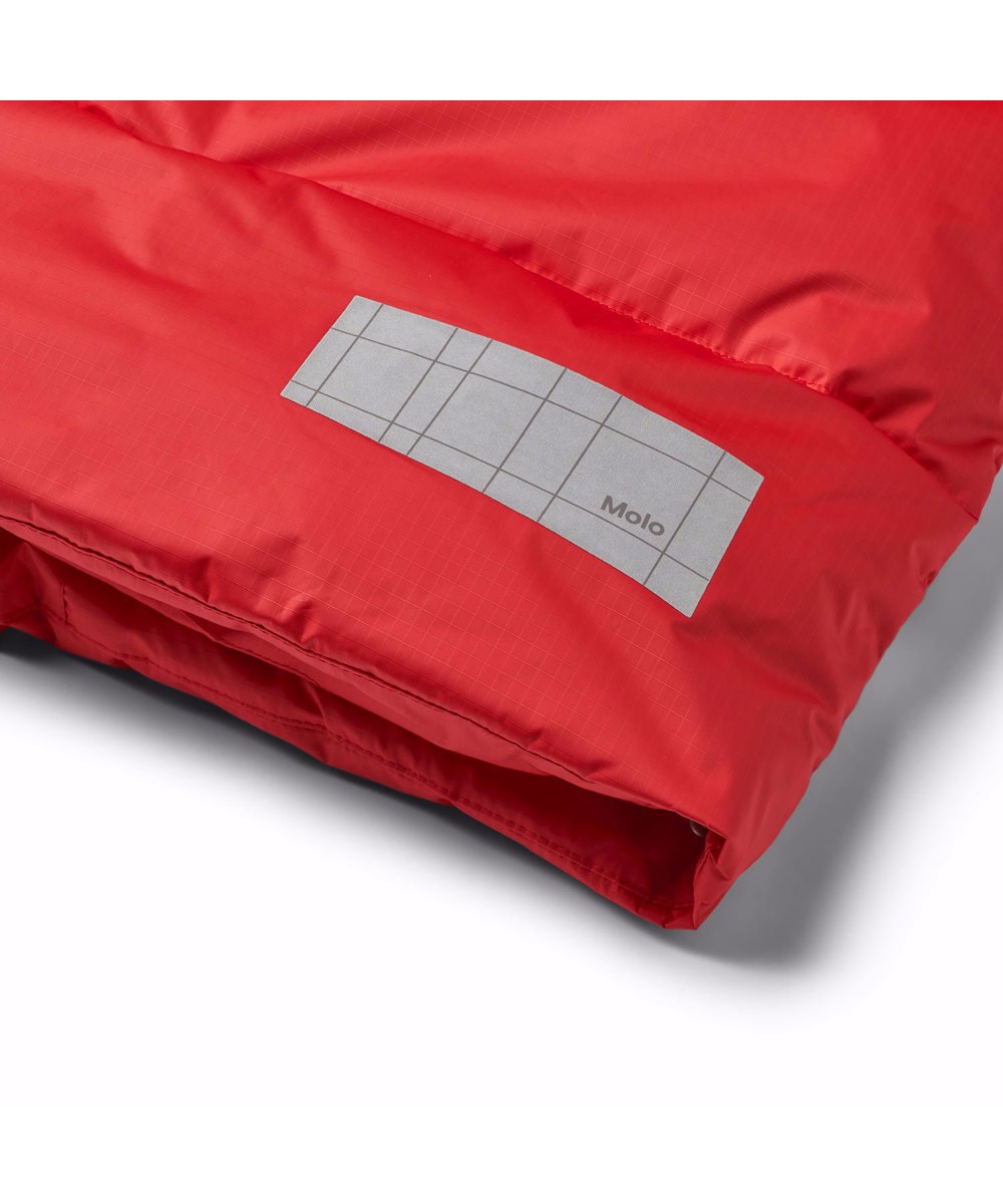 Hilo - Adrenaline Rush - Varm, rød dynejakke skabt til den kolde vinter, fremstillet af genanvendt polyester. Jakken har indbyggede vindfang i ærmerne og reflekser for øget synlighed i trafikken