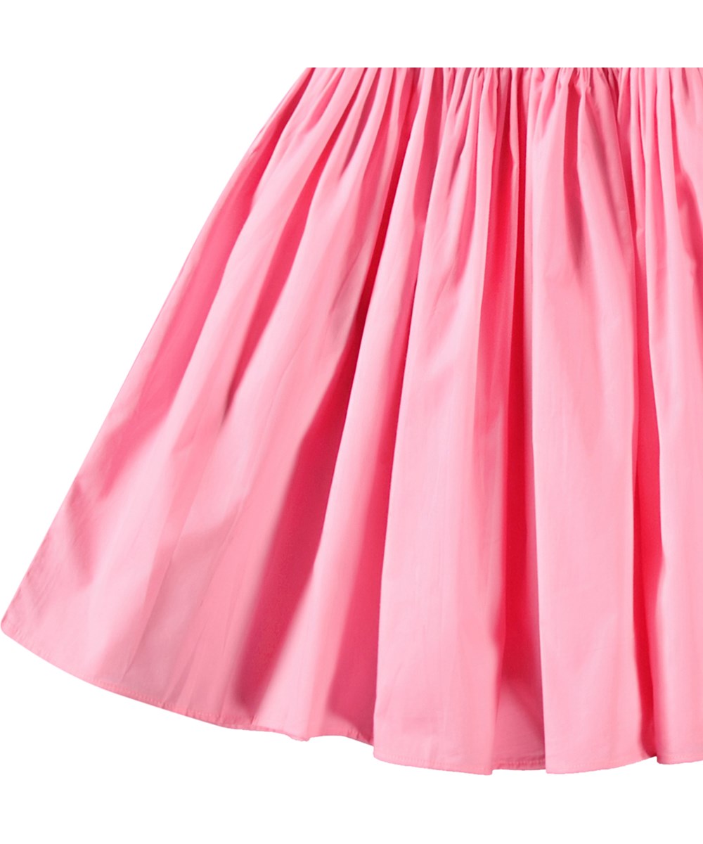 Cleopatra - Pink Lemonade - Kortærmet pink kjole til børn i økologisk bomuld med en tætsiddende jerseytop og et voluminøst skørt i bomuldspoplin.