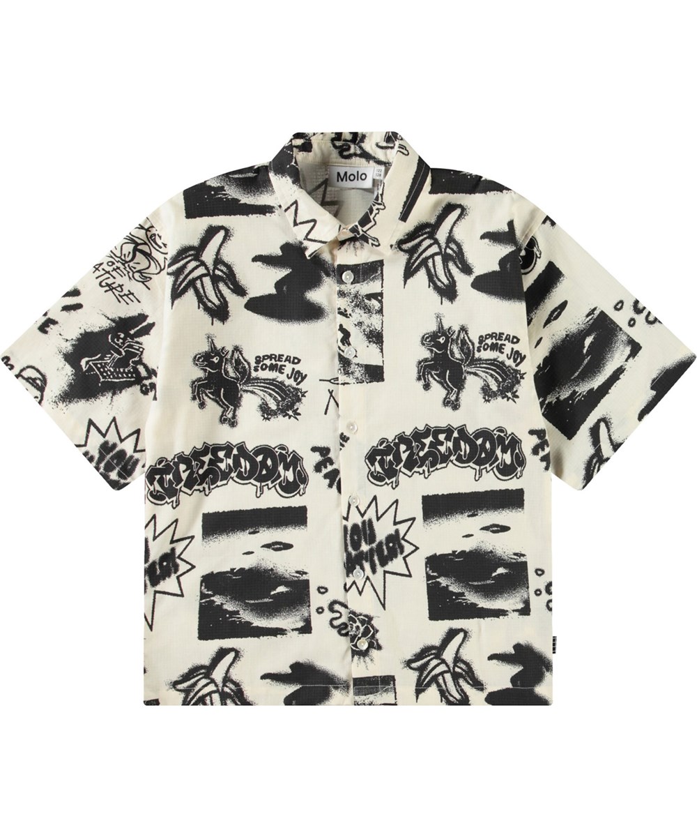 Richie - Art Mix - Beige tröja med tryck för barn i mjuk ekologisk bomull med vida t-shirt ärmar, klassisk skjortkrage och knappar framtill.