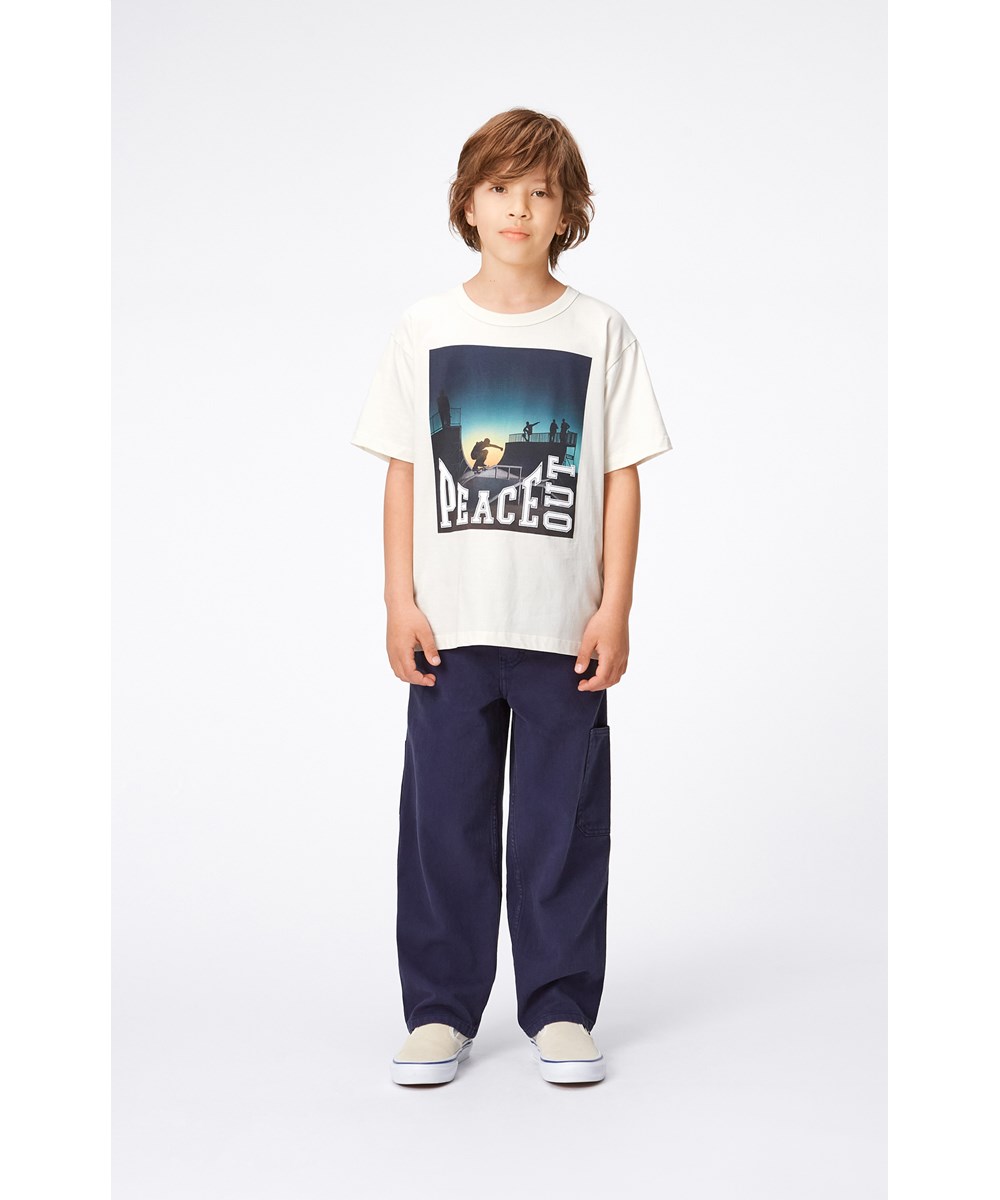 Riley - Peace Out Skate - Beige ekologisk t-shirt med skate mönster.