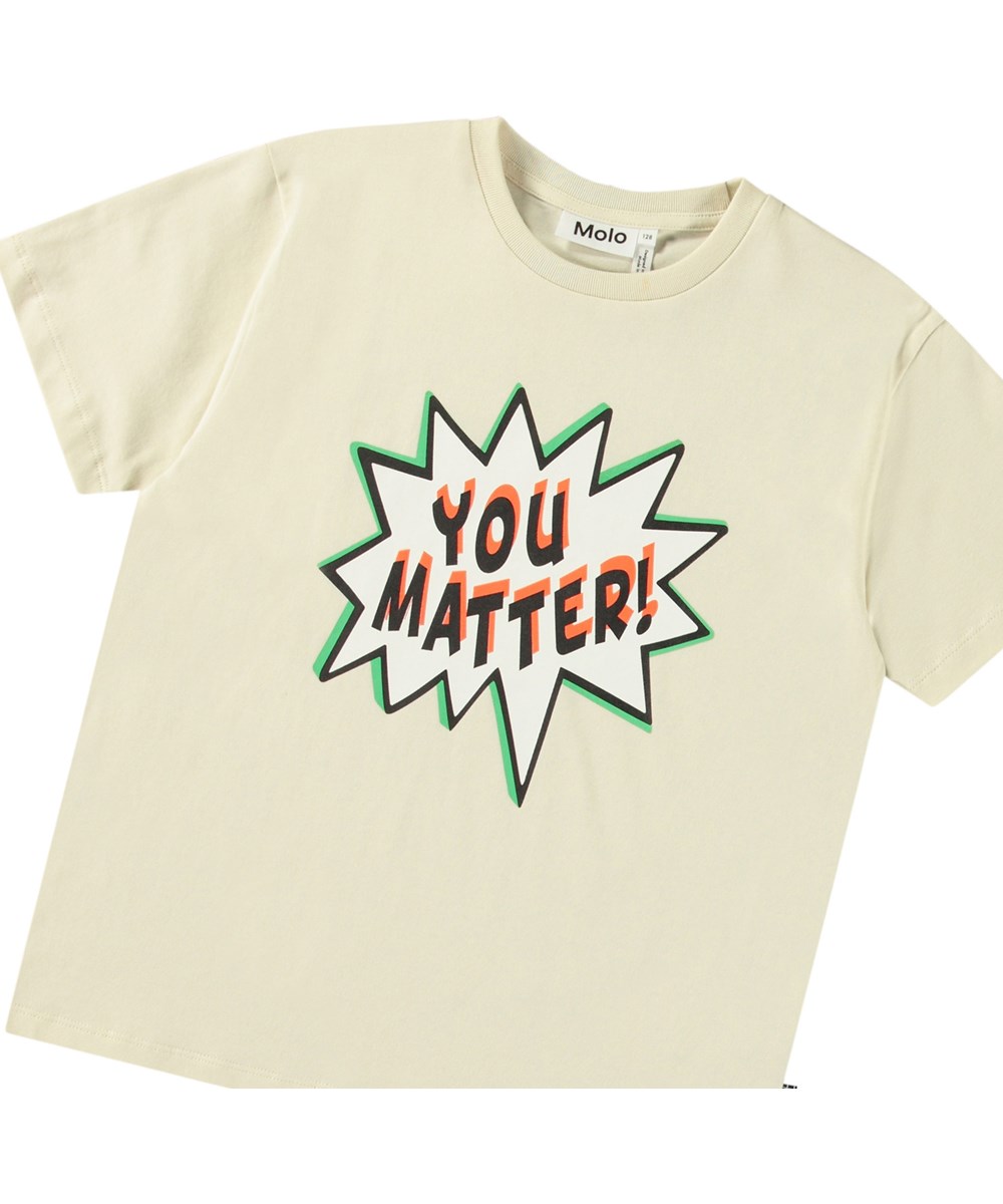 Riley - You Matter - Beige T-shirt med tryck för barn i mjuk ekologisk bomull med korta ärmar och ribbad halsringning.