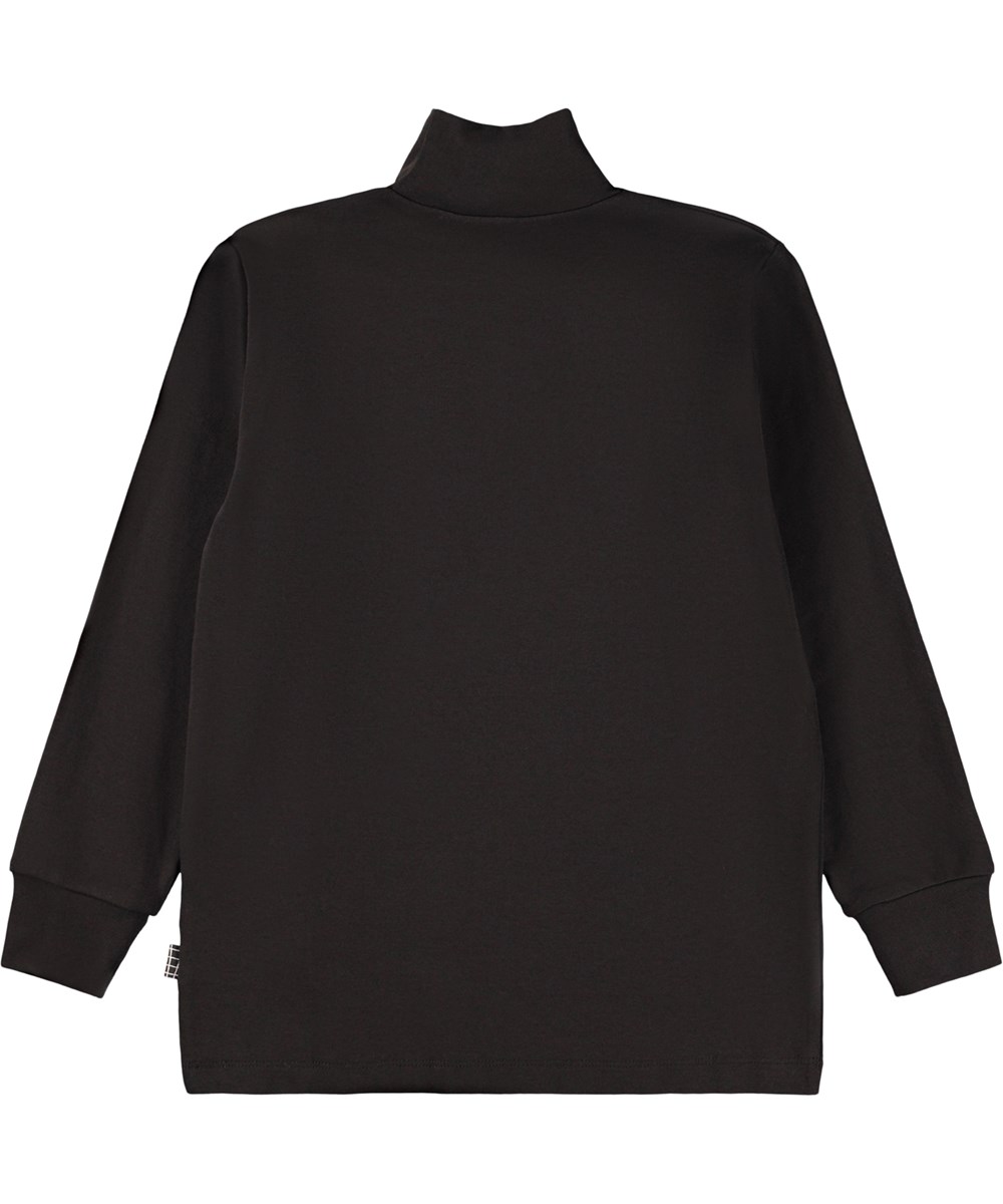 Ronoy - Black - Svart långärmad polotröja för barn i mjuk ekologisk bomull. Tröjan har en lös passform, ribbade ärmslut och ett litet broderat utomjordiskt ansikte på bröstet.