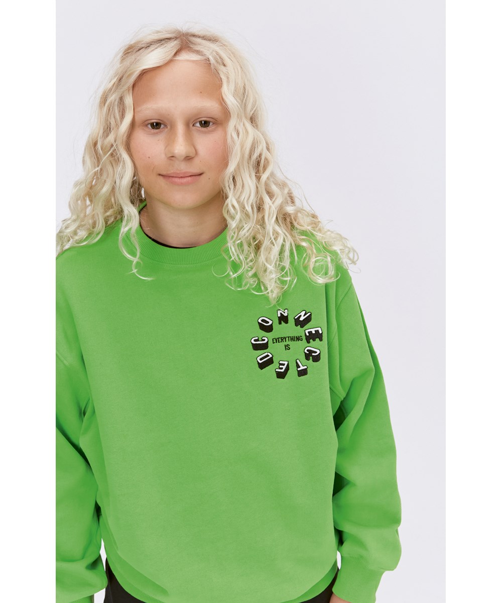Magni - Glowing Green - Grön ekologisk sweatshirt med grafiskt mönster.