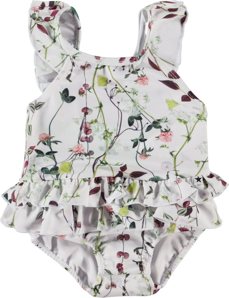 Nalani - Delicate Summer - Light blue baby swimsuit with ruffles and a floral print 