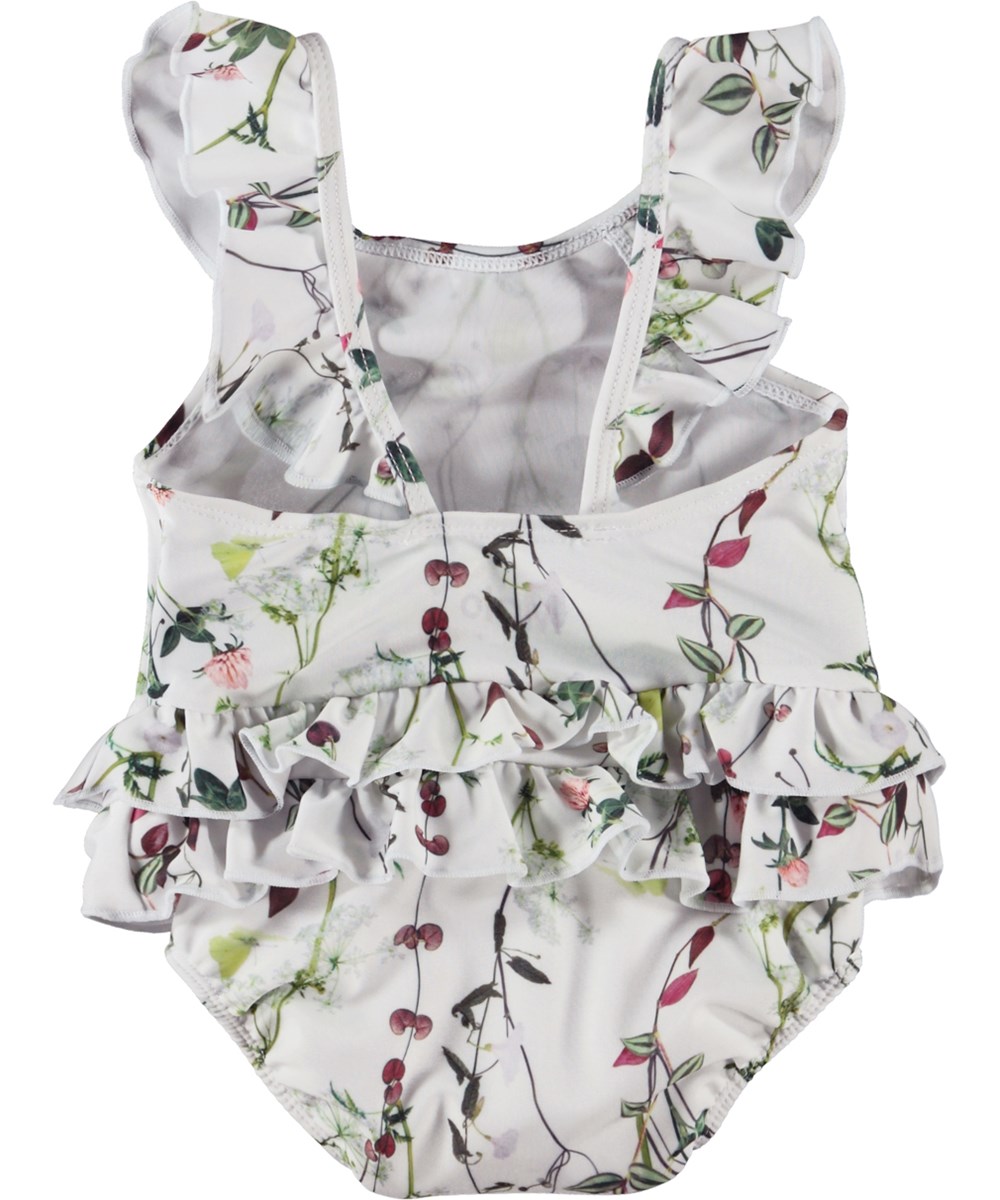 Nalani - Delicate Summer - Light blue baby swimsuit with ruffles and a floral print 