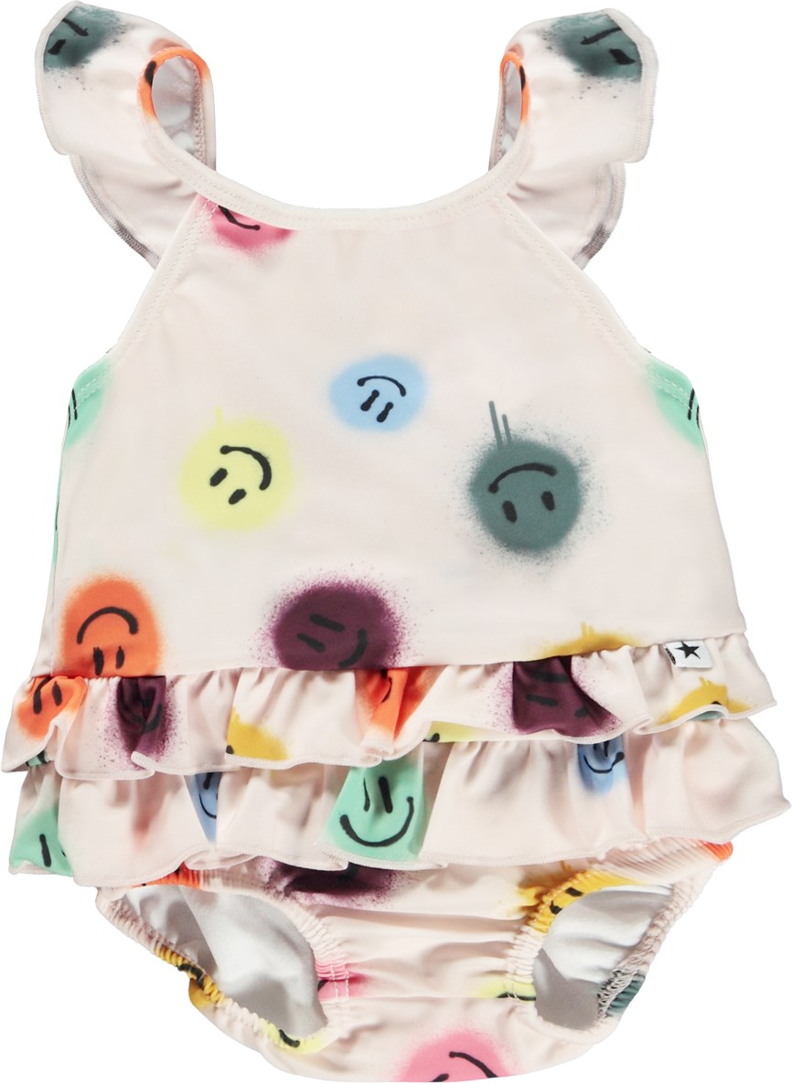 Nalani - Happy Dots - Rose baby swimsuit with ruffles and print of smiley faces