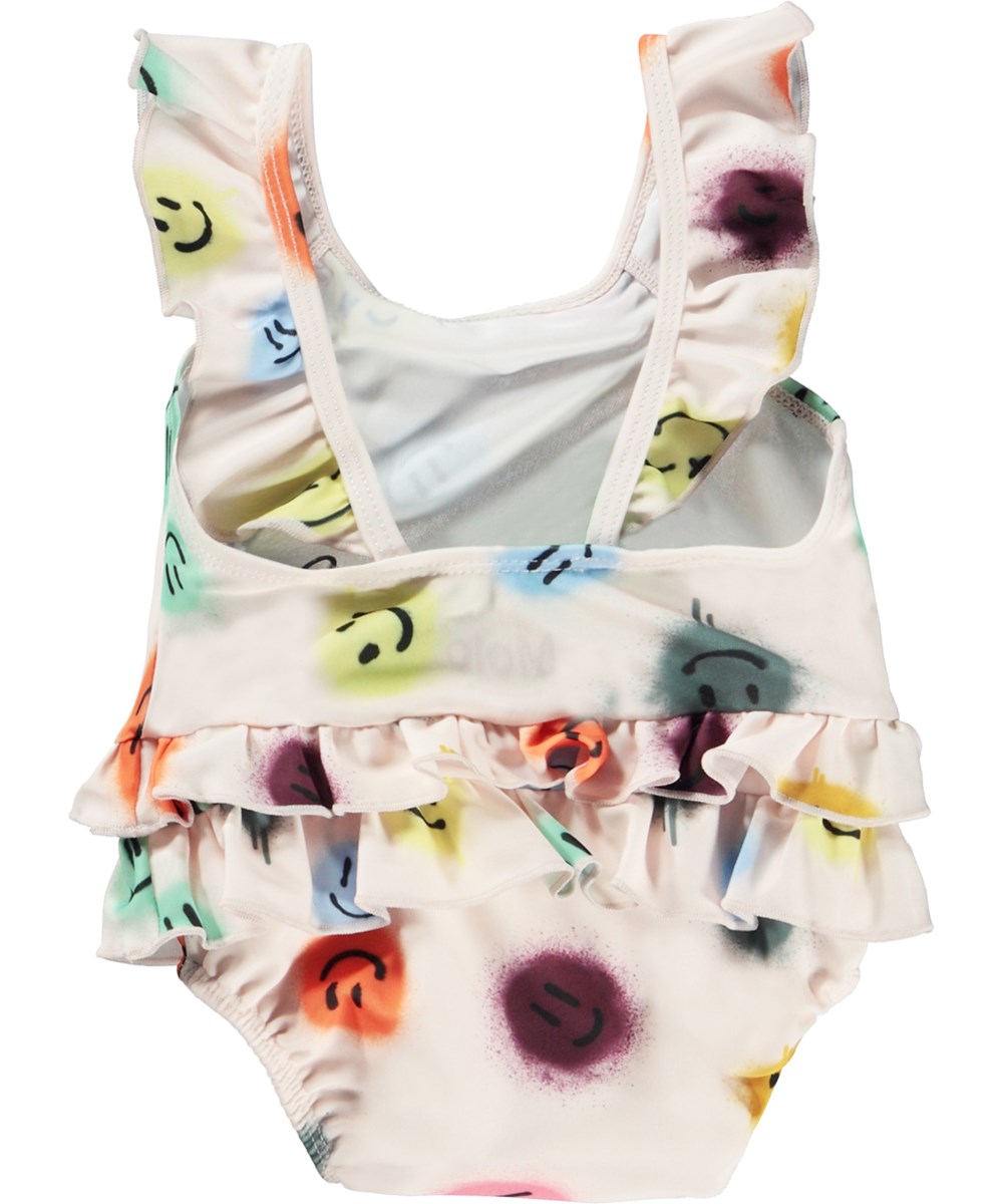 Nalani - Happy Dots - Rose baby swimsuit with ruffles and print of smiley faces