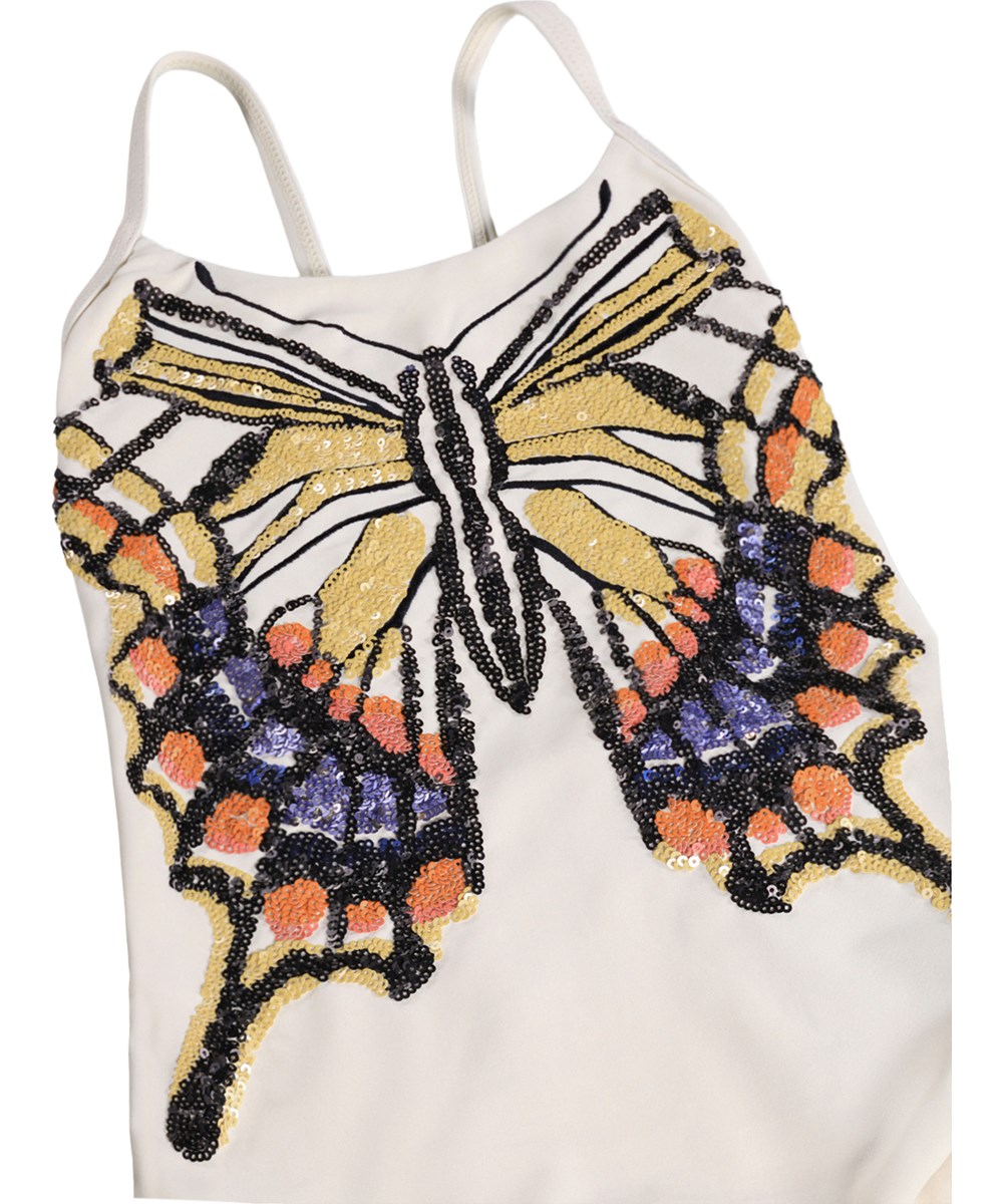 Nanna - Glitter Wings - White swimsuit with sequin motif for children made from recycled polyester with UV protection 50+.