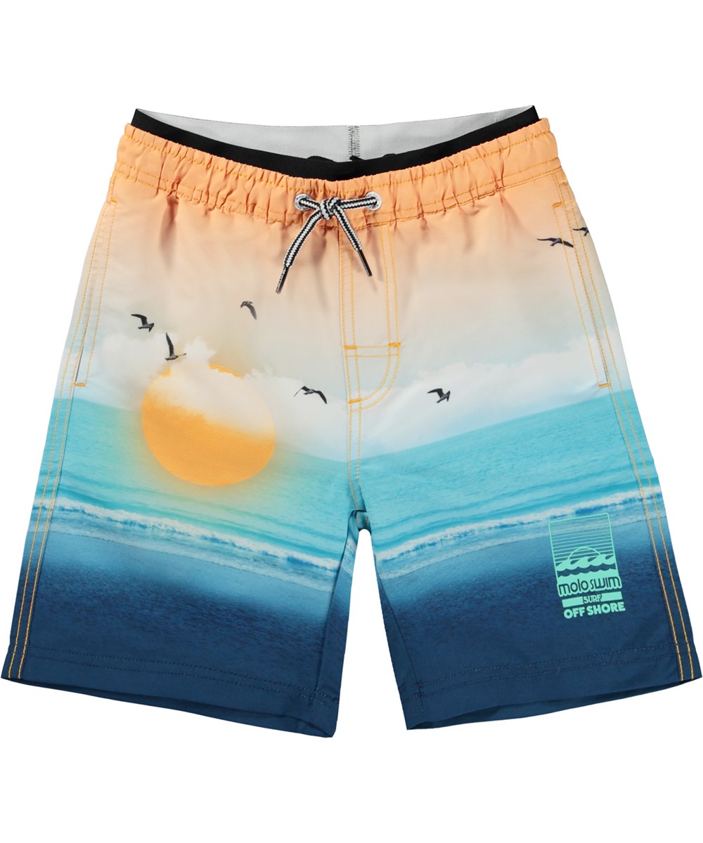 Neal - Sunset Beach - Orange and blue swim shorts with extra length and a placement sun and ocean print 