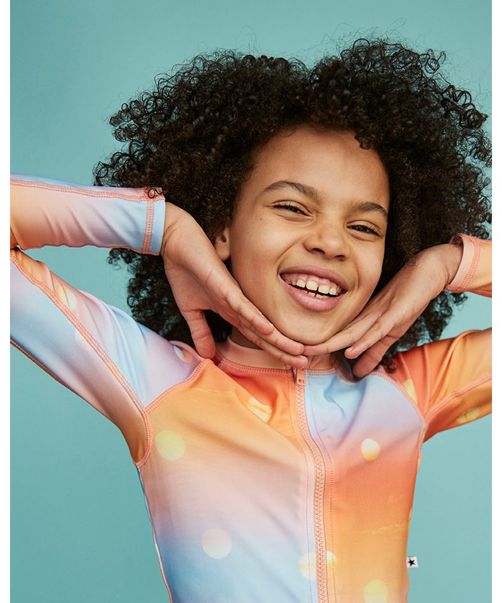 Nellie - Sun - UV sporty rash guard in orange and blue with small suns ...