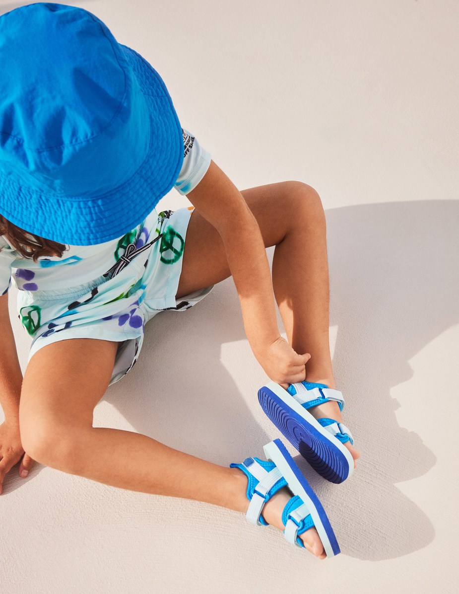 Neptune - Multi Smile - Classic rash guard in light blue with print of smiling faces, peace signs and yin/yang symbols 