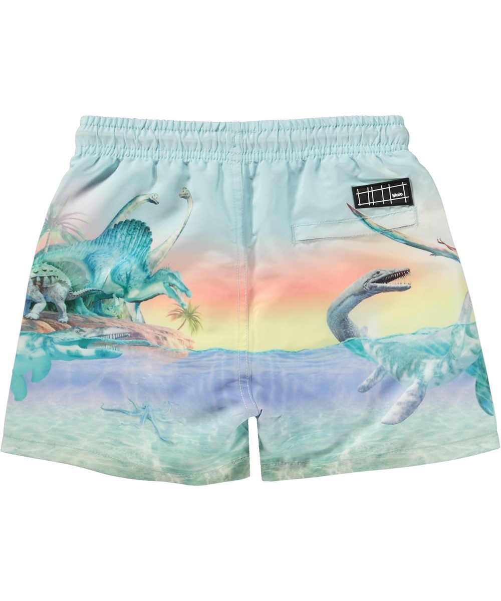 Niko - Ancient Island - Light coloured swim shorts with short legs and placement pastel dinosaur print 