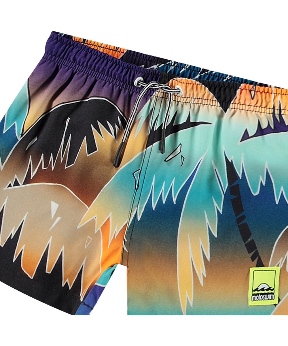 Niko - Faded Palmtrees - Sporty swim shorts for active children in recycled polyester with UV protection 50+.