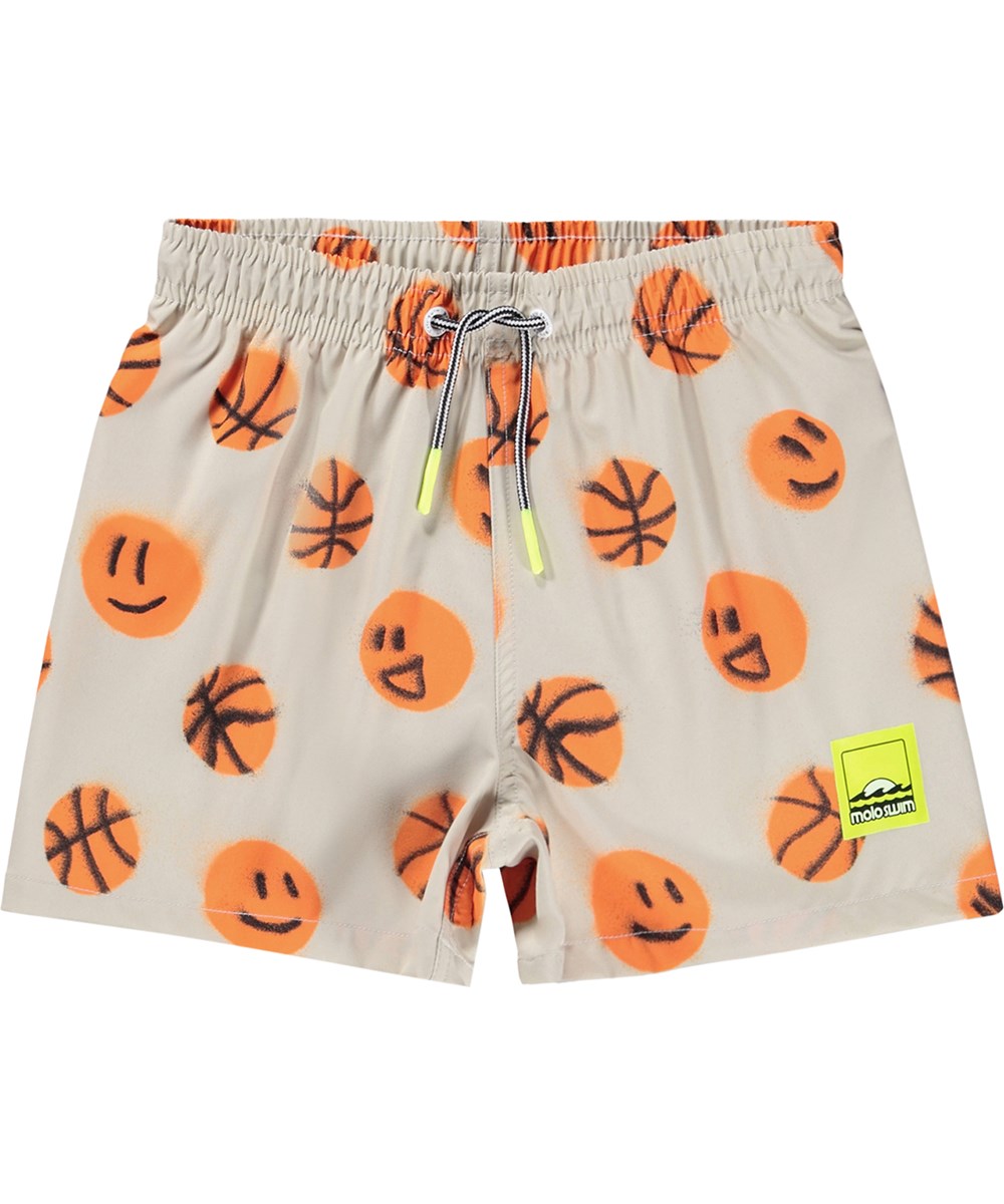 Niko - Fun Play - Sporty, beige swim shorts with basketball print for active children made from recycled polyester with UV protection 50+.
