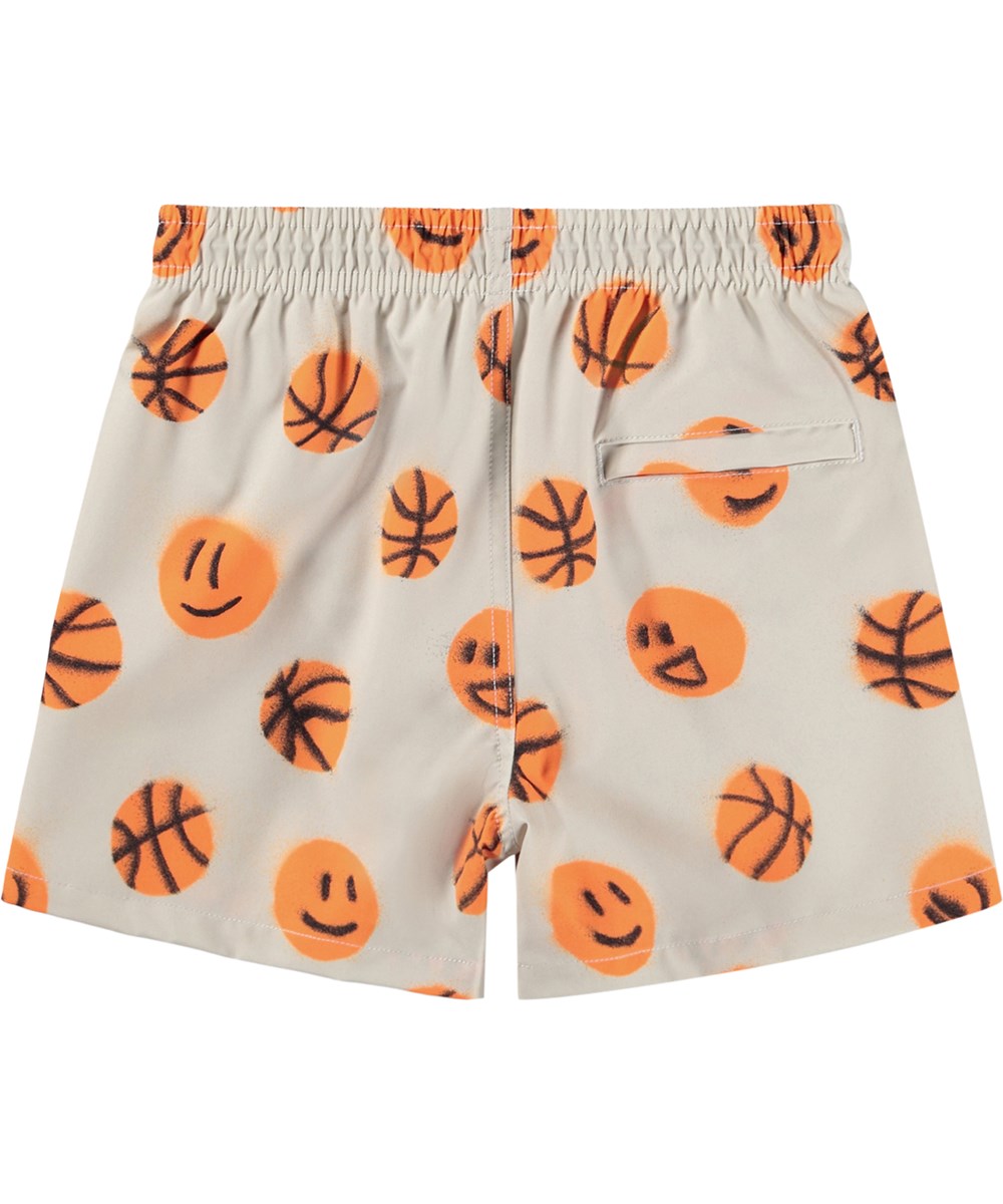 Niko - Fun Play - Sporty, beige swim shorts with basketball print for active children made from recycled polyester with UV protection 50+.
