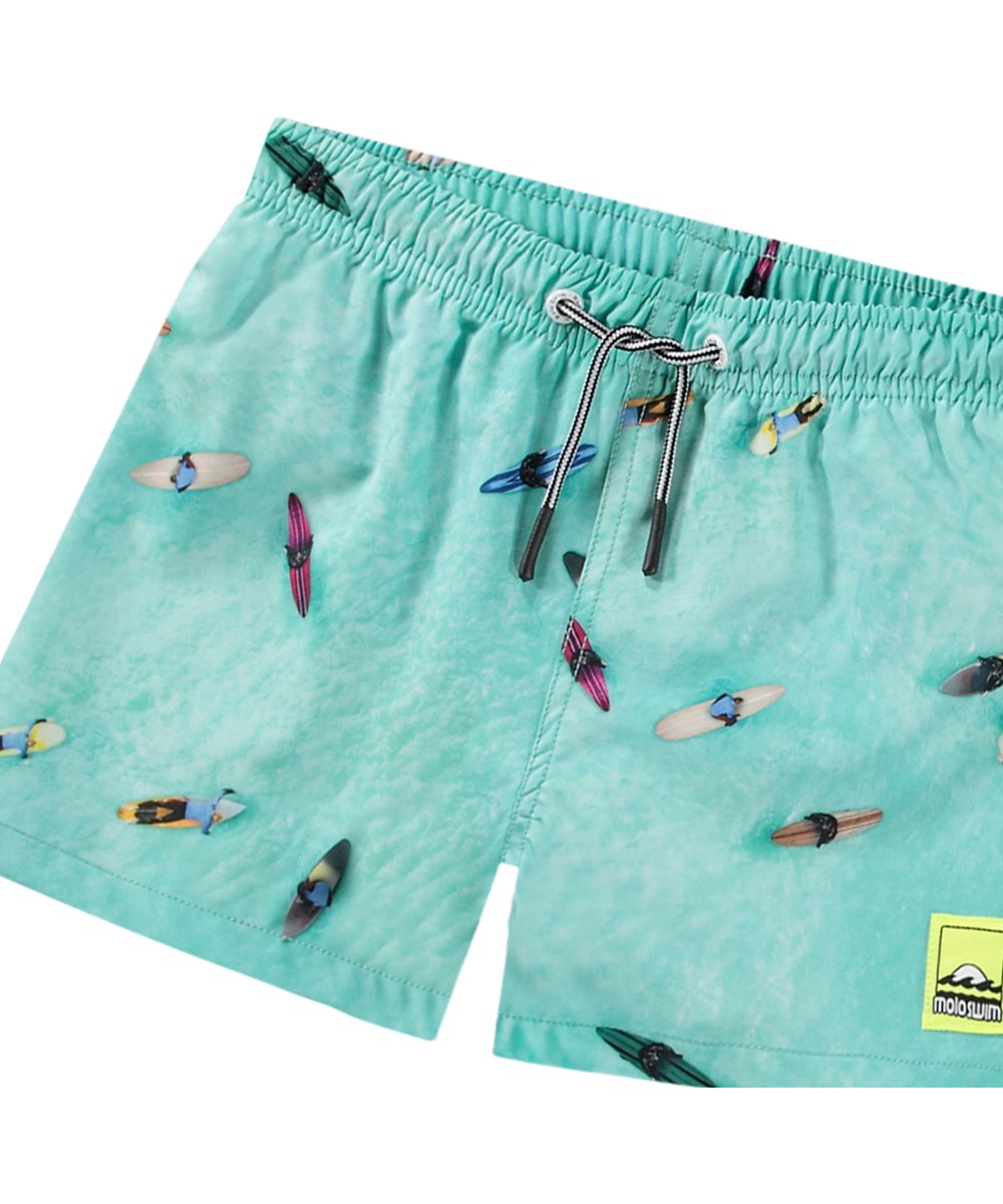 Niko - Ocean Surfers - Turquoise blue sporty swim shorts for active children in recycled polyester with UV protection 50+.