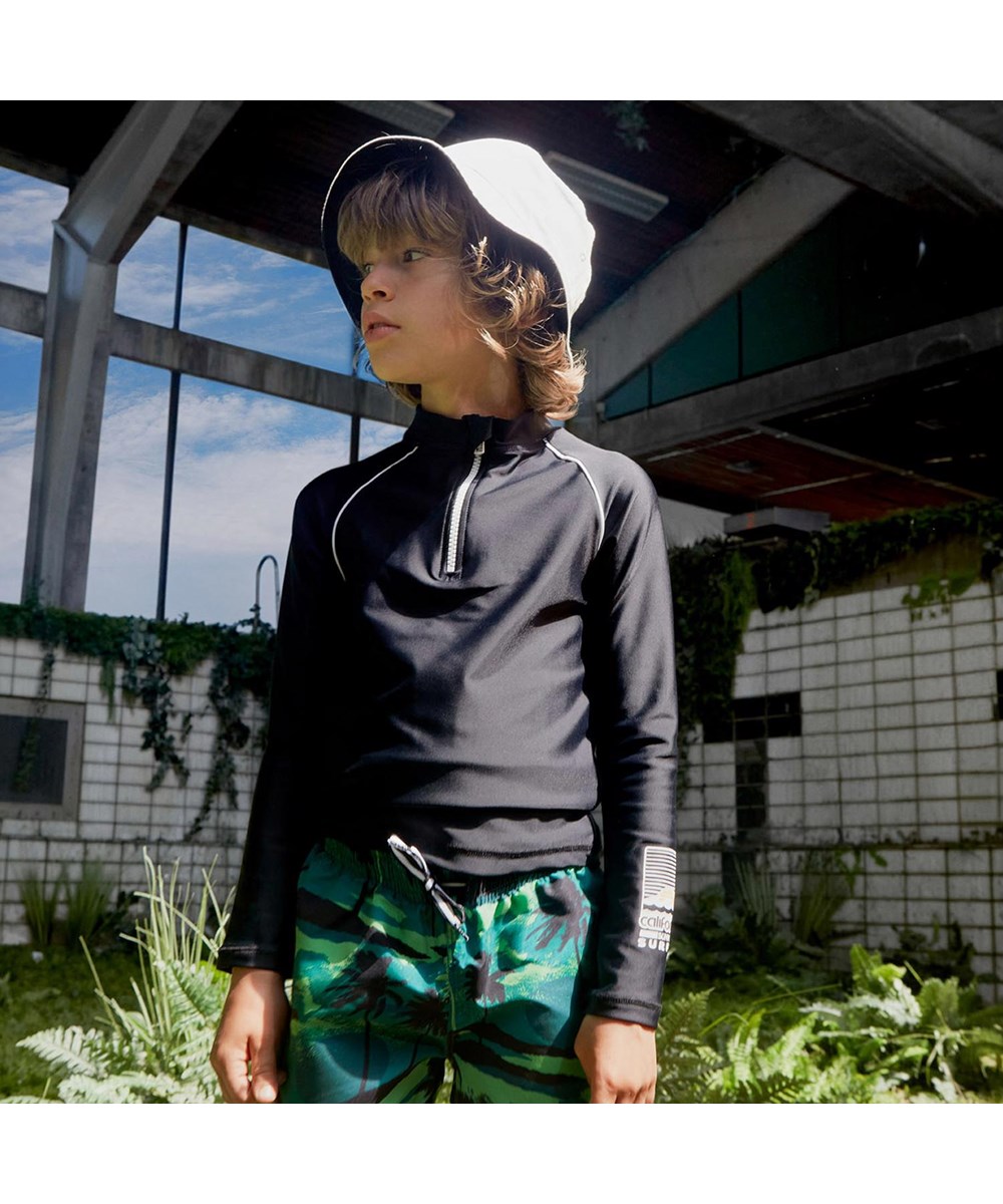 Niko - Palm Trees Green - Green UV swim trunks with palm tree print 