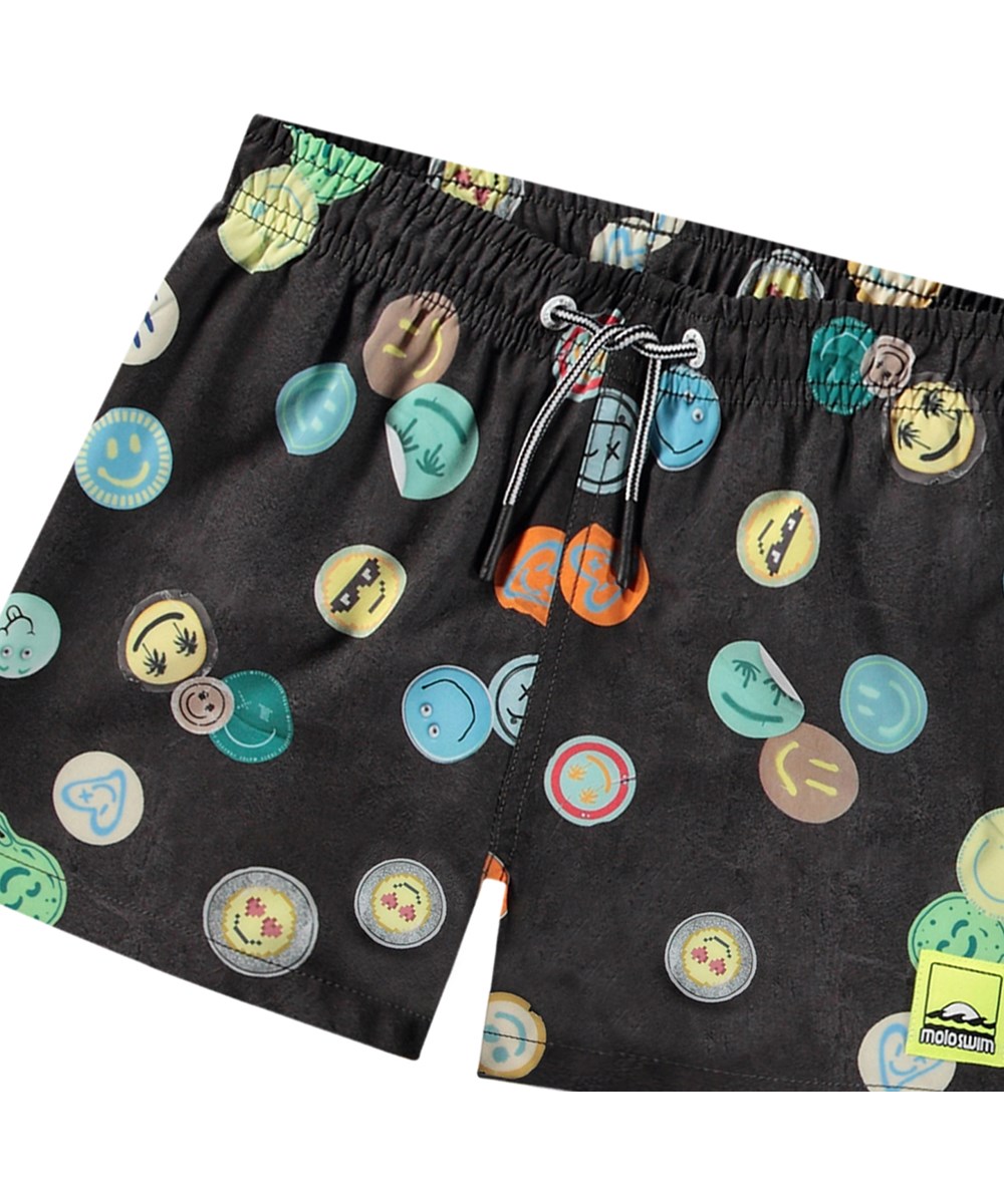 Niko - Smile All Over - Black sporty swim shorts for active children in recycled polyester with UV protection 50+.