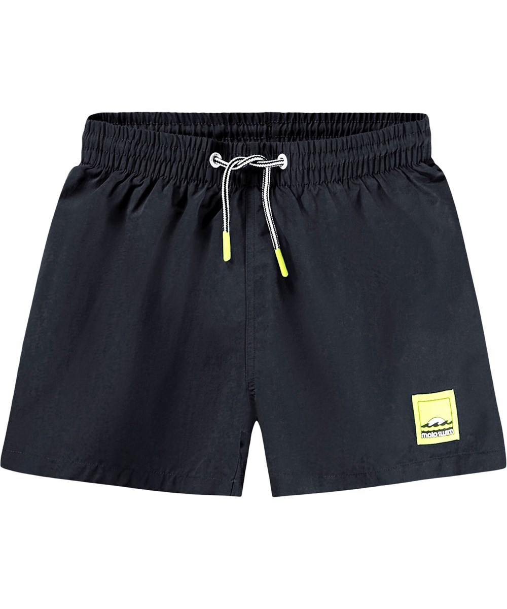 Niko Solid - Black - Black, sporty swim shorts for children made of recycled nylon with UV protection 50+.